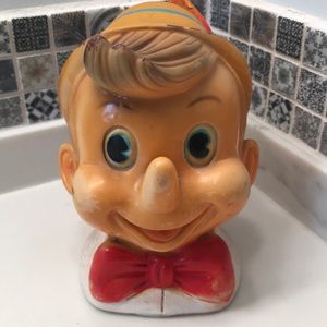 Vintage Pinocchio’s head plastic piggy bank